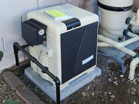 Pool gas heater installed on equipment pad next to filter